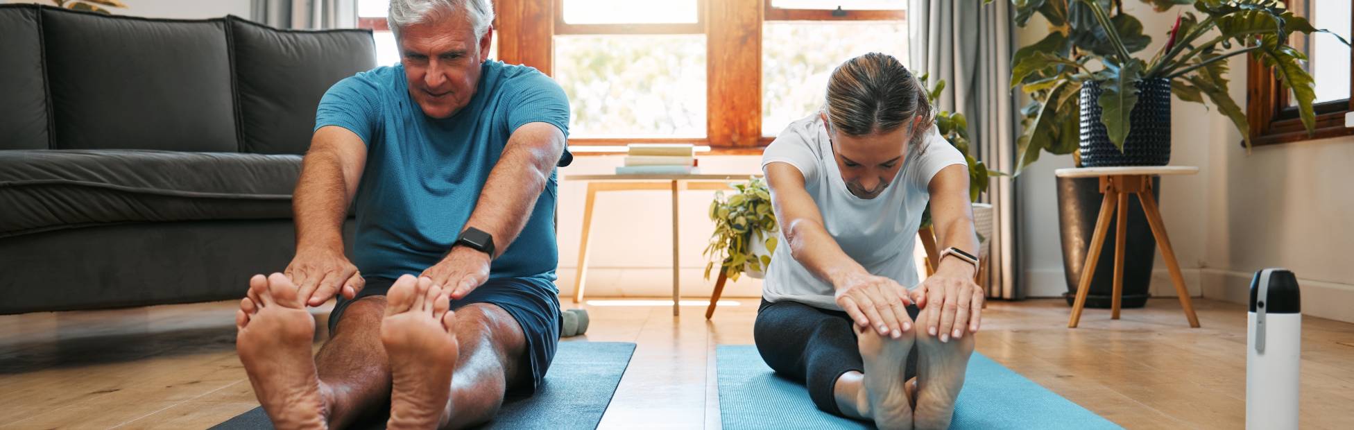 A man and woman doing yoga